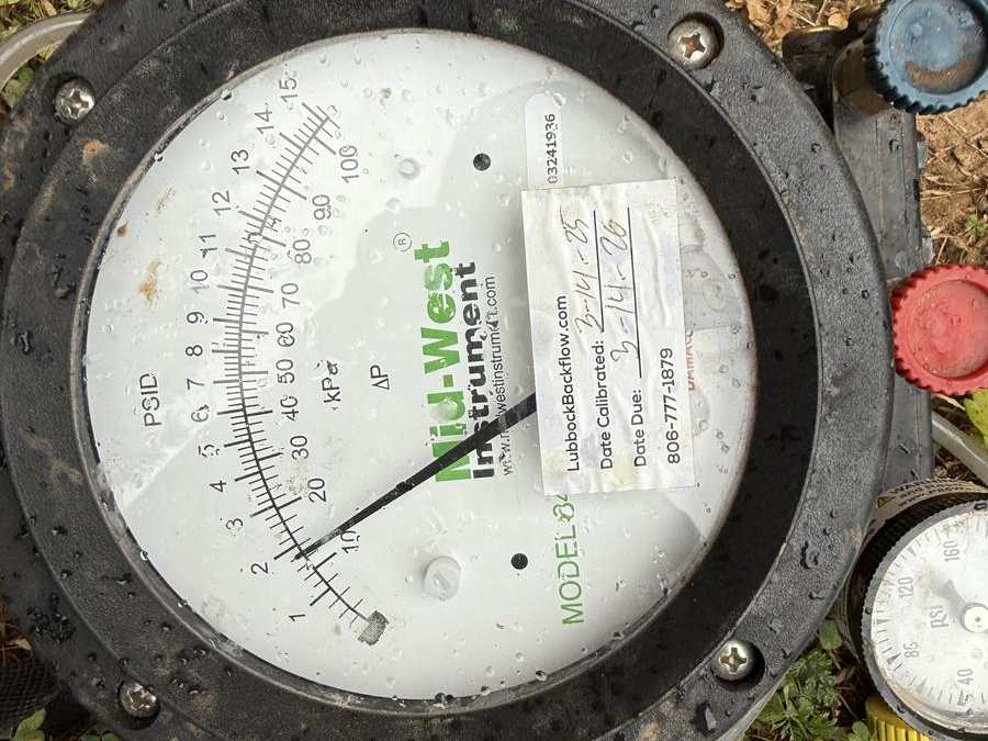 Backflow test kit gauge reading pressure in the field